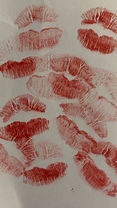 red lipstick imprints on white paper in the shape of lips with different shapes and sizes