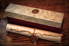 an empty roll of wax paper sitting on top of a wooden table next to a box