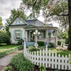 a white picket fence in front of a house