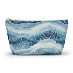 a blue and white cosmetic bag with waves on it