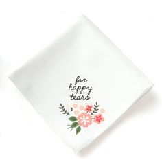 a white napkin with flowers on it and the words happy tears written in black ink