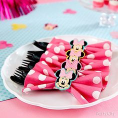 minnie mouse hair clips on a plate with pink and white polka dot tablecloths