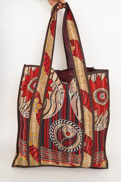 This bag is made from a vintage hand-stitched Kantha quilt. We make only 1-2 bags from each quilt and every one of them is one of a kind! Details: Shell fabric- Vintage quilted cotton Kantha 1. width (cm) - 35 2. height (cm)- 45 3. depth (cm) - 35 4. weight (g)- 0.400 kg 5. length of shoulder (cm) -25 cm Care instructions: Dry clean or Hand-wash in warm water. Drip dry. How it's made: Kantha quilts are made using numerous layers of recycled silk or cotton saris which are hand-stitched in the tra Brown Rectangular Hobo Bag With Patchwork, Red Patchwork Tote Bag, Red Patchwork Tote Shoulder Bag, Red Patchwork Shoulder Bag For Daily Use, Brown Patchwork Rectangular Bag, Brown Rectangular Patchwork Bag, Rectangular Brown Patchwork Bag, Red Quilted Rectangular Shoulder Bag, Kantha Bag