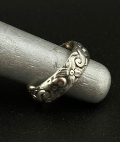 Embrace the regal elegance of the past with our Thick Engraved Old English Style Sterling Silver 925 Ring. This statement band draws inspiration from the rich heritage of Old English artistry, featuring deep, intricate engravings that embody the era's grandeur. Crafted from high-quality sterling silver 925, this ring is not just a piece of jewelry but a bold statement of vintage-inspired luxury. Designed for those who appreciate the beauty of historical designs and the timeless appeal of sterling silver, this ring makes a striking addition to any collection. Whether worn as a standout piece or paired with other favorites, it promises to bring a touch of sophistication and old-world charm to your ensemble. Vintage Adjustable Engraved Ceremonial Ring, Classic Silver Engraved Ring For Ceremonial Occasions, Vintage Silver Engraved Ring For Ceremonial Use, Vintage Silver Engraved Ring For Ceremonial Occasions, Vintage Silver Engraved Ring For Ceremonies, Adjustable Engraved Antique Silver Ring, Classic Silver Ring With Intricate Engraving, Classic Ceremonial Engraved Ring With Etched Details, Classic Sterling Silver Engraved Ring For Ceremonial Occasions