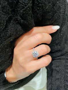 a woman's hand with a diamond ring on it