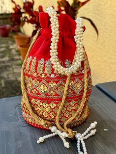 Beautiful embroidered silk potli purse handmade in India.  8" x 7.5" Festive Gold Embroidered Potli Bag, Traditional Gold Embroidered Fabric For Celebration, Traditional Gold Embroidery Potli Bag, Red Embroidered Potli Bag For Party, Festival Multicolor Embroidery Potli Bag With Zari Work, Festive Multicolor Embroidered Potli Bag With Handwork, Multicolor Embroidery Zari Work Potli Bag For Festivals, Festive Multicolor Embroidered Handwork Potli Bag, Traditional Multicolor Embroidered Pouch For Gifts