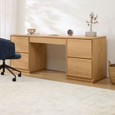 an office desk with a chair next to it and a rug in front of it