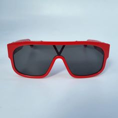 These modern Louis Vuitton 1.1 Millionaire Mask Sunglasses feature a contemporary mask shape with a full lens, a red acetate frame, S-lock hinges with LV initials and a discrete Monogram pattern on the top bar. Model: Z1260W Size: W - Western Material: Acetate Made in: Italy Condition: NEW with original Louis Vuitton box & dust bag, no case. Western Material, Louis Vuitton Box, Mask Sunglasses, Mask Shapes, Bar Model, Monogram Pattern, Bar Top, Hinges, Initials