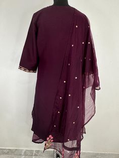 Product Details Burgundy embroidered Kurta with Trousers with dupatta Kurta design: Floral embroidered Straight shape * Regular style Round neck, three-quarter regular sleeves Zari detail * Calf length length with scalloped hem * Art Silk  fabric Trousers design: * Embroidered Trousers * Elasticated waistband * Slip-on closure Material& Care Kurta Fabric: Art Silk Bottom Fabric: Art Silk Dupatta Fabric: Organza hand wash  Items includes One piece Kurta One piece Dupatta One piece Trouser Note:- Please see the size chart in the image to choose a perfect size. Please feel free to ask any questions regarding this item WE ALSO ACCEPT CUSTOMISATION AS PER CUSTOMER REQUESTS. Embroidered Purple Palazzo Set With Straight Kurta, Fitted Purple Chanderi Palazzo Set, Purple Straight Kurta With Sheer Dupatta, Traditional Cotton Dress With Sheer Dupatta, Purple Chikankari Embroidery Set For Transitional Season, Purple Chikankari Embroidery Kurta, Transitional Purple Chikankari Sets, Purple Chikankari Sets For Transitional Season, Transitional Purple Set With Chikankari Embroidery