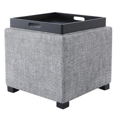 a grey ottoman with black legs and a tray on the top, in front of a white background