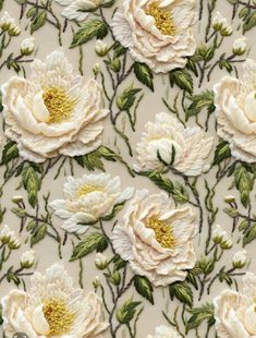 white flowers with green leaves and stems on a beige background that is embroidered onto the fabric