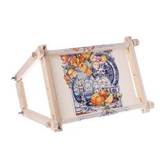 a wooden frame holding a painting with flowers on the front and bottom, in white background