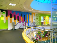 an office building with colorful walls and stairs