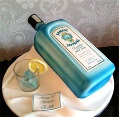 a cake that has a bottle on top of it