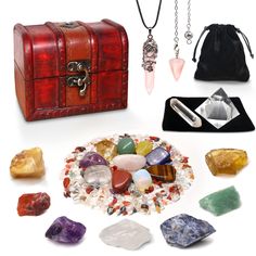 a collection of rocks, crystals and other items on a white surface next to a red leather case