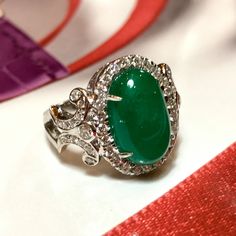 MADE TO ORDER ONLY! 1 week gold crafting period. EXTREMELY VIVID, Certified 7.57 carats, COLOMBIAN Emerald ring. SUGGESTED RETAIL VALUE: $18,000 EMERALD: Weight: 6.63 carats Shape: Oval Cabochon Dimensions: 9.27 x 14.73 x 5.90 mm Color: Green Origin: COLOMBIAN NATURAL EMERALD WITH OIL TREATED ONLY (F3) Gemological certificate provided as shown. TRANSPARENT EXTREMELY CLEAN EXCELLENT COLOR AND CUT! RARE VIVID, COLOMBIAN, BLUISH-GREEN COLOR!! DIAMONDS: 50 round brilliant diamonds weighting a total Luxury Diamond Gemstones With Cabochon Cut, Luxury Diamond Cabochon Gemstones, Luxury Oval Cabochon Gemstones For Anniversary, Luxury Oval Cabochon Diamond Gemstones, Luxury Cabochon Diamond Ring For Formal Occasions, Luxury Formal Cabochon Diamond Ring, Formal Hallmarked Diamond Cabochons, Luxury Emerald Ring With Oval Cabochon, Luxury White Gold Diamond Cabochons