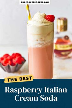 the best raspberry italian cream soda in a tall glass with strawberries on top