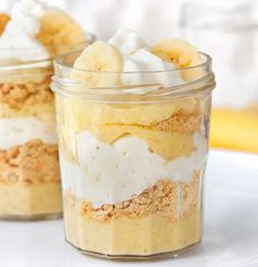 two jars filled with food sitting on top of a white tablecloth next to each other