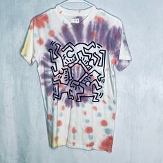 Keith Haring Short Sleeve Shirt. Purple, Pink, Yellow And Blue Tie Dye With Black Graffiti Print. 100% Cotton. Machine Washable. New With Tags. Size Xs. Fun Purple Crew Neck T-shirt, Purple Summer Tops With Graphic Design, Summer Purple Tops With Graphic Design, Purple Graphic Crew Neck Top, Multicolor Cotton Tops With Graffiti Print, Fun Purple Short Sleeve T-shirt, Multicolor Graffiti Print Relaxed Fit Top, Purple Graphic Design T-shirt For Summer, Fun Purple Crew Neck Top