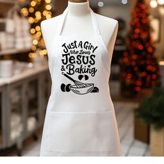 a white apron that says just a girl who loves jesus and baking