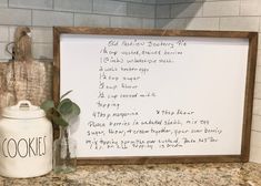 a kitchen counter with a cookie recipe written on the side and a jar next to it