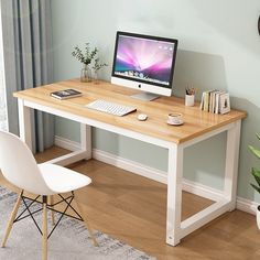 a desk with a computer on it and a chair next to it in front of a window