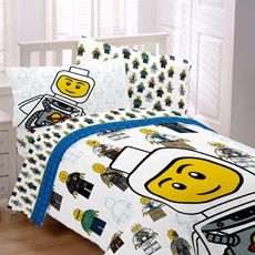 a bed with legos on it in a bedroom next to a white dresser and window