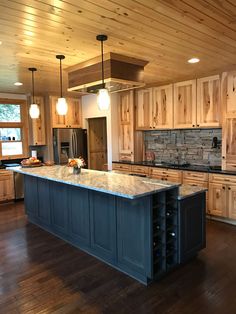 a large kitchen with wooden cabinets and an island