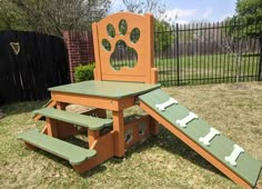 an outdoor play set with a dog's paw print on the back