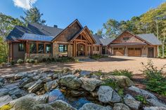 a large house surrounded by rocks and trees