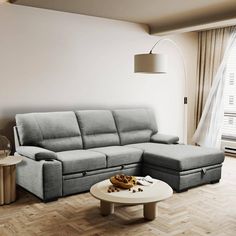 a living room with a couch, coffee table and lamp on the wall next to it