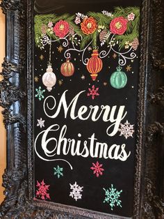 a chalk board with christmas decorations on it