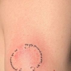 a small tattoo on the back of a woman's shoulder