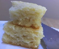 two pieces of cake sitting on top of a white plate with a knife next to it