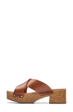 A woodgrain platform gives heritage clog-inspired style to a sandal that ensures comfort with contoured cushioning. Cushioned footbed with arch support Leather upper/textile lining/synthetic sole Imported Casual Open Toe Wooden Sandals, Casual Sandals With Wooden Heel, Casual Wooden Sandals For Summer, Brown Beach Clogs With Cushioned Footbed, Wood Sandals With Removable Insole, Casual Open Toe Wooden Mules, Brown Clogs With Cushioned Footbed For Beach, Casual Open Toe Wooden Clogs, Calf Leather Slip-on Sandals With Cushioned Footbed