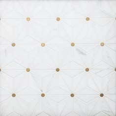 a white wall with gold dots on it