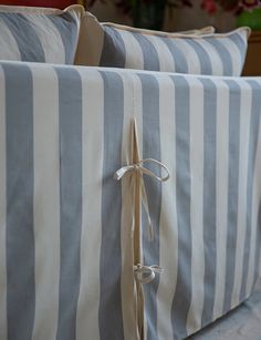 two blue and white striped pillows tied together