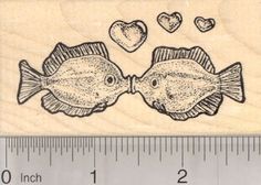 a rubber stamp with two fish and hearts