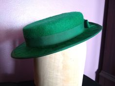 This handmade hat can work for multiple eras! Tilt it to the side for 1930s or 1940s, or wear it straight across for a turn of the century look. Since this hat sits at the top of the head, it will fit most head sizes. As such, it will need to be secured with something, like a hat pin. Green Fitted Hat Band For Kentucky Derby, Retro Fitted Brimmed Felt Hat, Fitted Green Hat Band For Kentucky Derby, Fitted Green Hat Bands For Kentucky Derby, Fitted Green Felt Hat For Winter, Vintage Fitted Hat Bands For Party, Fitted Brimmed Hat For Vintage Fashion, Vintage Fitted Fedora Mini Hats, Retro Fitted Top Hat With Wide Brim