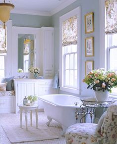 an image of a white bathroom with flowers in the tub