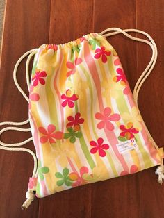 a drawstring bag sitting on top of a wooden floor with the words sew practical