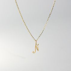 A timeless piece that will never go out of style. This 14K gold calligraphy pendant is the perfect and most stunning way of keeping a name close to your heart. We handmade each piece so you can assure you're getting a one-of-a-kind pendant that is not like any other. This 14K solid gold letter pendant is flawlessly crafted to look super chic and elegant around your neck. Pair it with a nice gold chain and wear it with almost all of your outfits. The piece is such a versatile lettering necklace. N Necklace, N Initial, Gold Letter Pendants, Initial N, Gold Calligraphy, Orange Necklace, Gold N, Fabric Necklace, Gold Letter