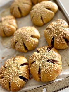 freshly baked buns with sesame seeds on a baking sheet