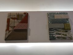 three different types of fabric on display in a room with white walls and flooring