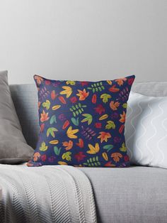 a blue background with colorful autumn leaves on it throw pillow by designbybear