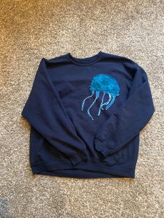 Hand sewn lettering, you can choose the color of the words and jellyfish! Blue Embroidered Crew Neck Hoodie, Blue Crew Neck Hoodie With Embroidered Graphics, Blue Casual Sweater With Letter Embroidery, Casual Blue Sweatshirt With Letter Embroidery, Blue Streetwear Sweatshirt With Embroidered Text, Blue Embroidered Text Sweatshirt For Streetwear, Blue Sweatshirt With Embroidered Text For Streetwear, Jellyfish Outfit, Sewed Clothes