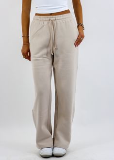 Stay cozy and stylish with these straight leg sweatpants! Featuring a relaxed straight-leg design with convenient pockets and a drawstring waist, these sweatpants are perfect for lounging or running errands. The soft fabric ensures all-day comfort, while the versatile beige hue makes them easy to style with your favorite casual tops. The Details Pockets Drawstring Waist Straight Leg 50% Cotton, 50% Polyester [#other] Machine Wash Cold with Like Colors Tumble Dry Low for 5 Minutes, Then Hang to D Solid Color Drawstring Sweatpants For Loungewear, Loose Fit Drawstring Sweatpants For Lounging, Loosely Fitted Sweatpants With Drawstring For Loungewear, Comfortable Straight Leg Pants With Drawstring, Solid Color Drawstring Sweatpants For Lounging, Cozy Drawstring Pants For Loungewear, Wide Leg Joggers With Drawstring For Lounging, Winter Drawstring Pants For Lounging, Drawstring Pants For Winter Lounging