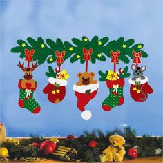 christmas stockings and teddy bears hanging from a tree