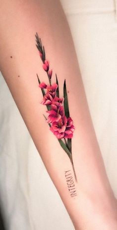 a woman's arm with pink flowers on it