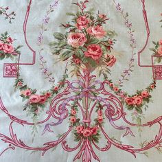 an embroidered tablecloth with pink flowers and vines on white background, in the middle of a circular design